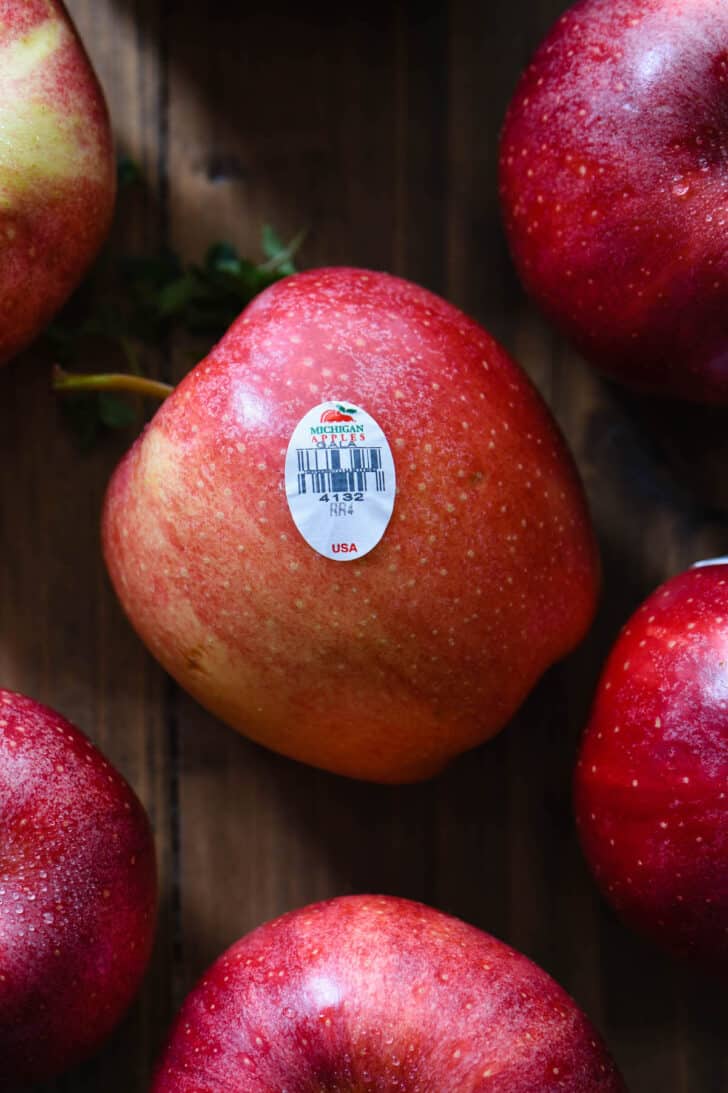 Closeup on fresh apples with a Michigan Apples sticker on one.