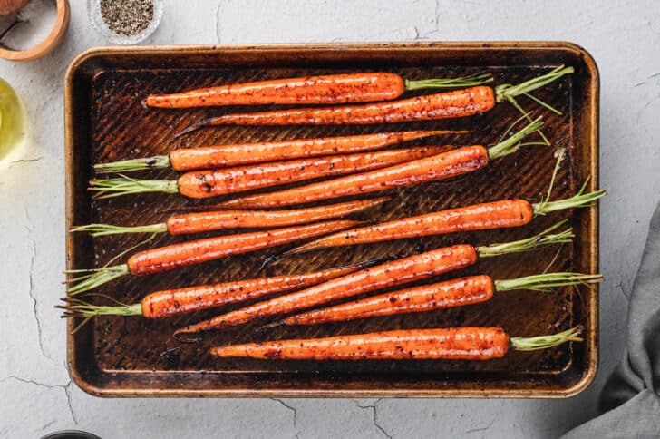 Roasted root vegetables on a rimmed baking pan.