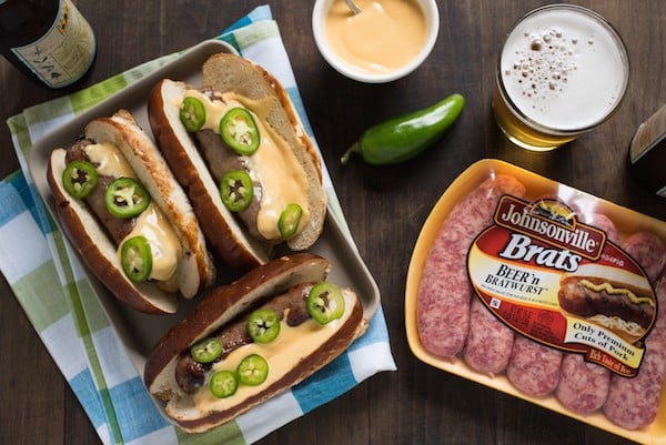 Beer Brats with Beer Queso - For the beer and grilling lovers in your life! Beer-flavored bratwurst topped with a sharp cheddar-beer queso. Serve with beer! | foxeslovelemons.com