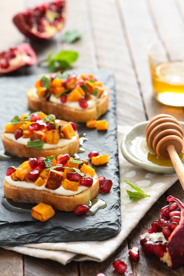 Butternut Squash & Pomegranate Crostini with Whipped Feta and Honey - This autumn appetizer is the perfect balance of sweet and savory. Set these out at your next party and watch them disappear! | foxeslovelemons.com