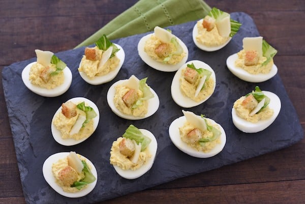 Caesar Salad Deviled Eggs - For this fun take on deviled eggs, egg yolks are mixed with classic Caesar salad flavors and Greek yogurt. If desired, garnish with lettuce, shaved Parmesan cheese and a crouton! | foxeslovelemons.com