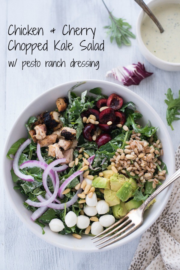 Chicken & Cherry Chopped Kale Salad with Pesto Ranch Dressing - A colorful and delicious mix of greens, chicken, cherries, farro, avocado, mozzarella cheese, red onions and pine nuts, tossed with homemade pesto ranch dressing! | foxeslovelemons.com