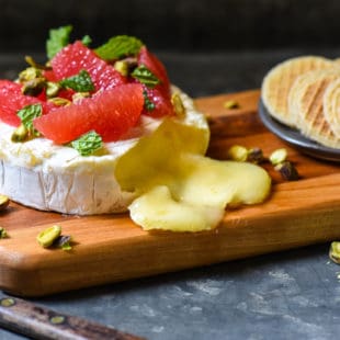 With just 4 ingredients and a 10 minute prep time, this Easy Baked Brie with Grapefruit & Pistachios is ideal for a party, or just a delicious snack at home. | foxeslovelemons.com