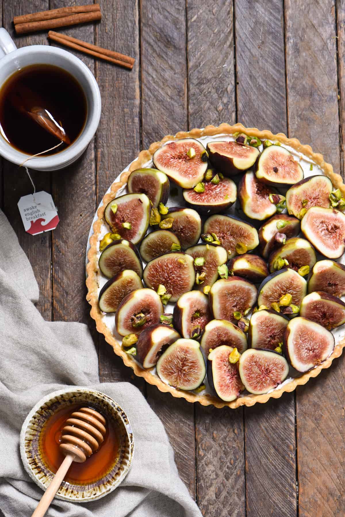 Fig & Spiced Goat Cheese Tart - A "dessert" for all the cheese lovers out there. Ripe figs are piled into a flaky crust on top of sweet and savory spiced goat cheese, then topped with honey and pistachios. | foxeslovelemons.com