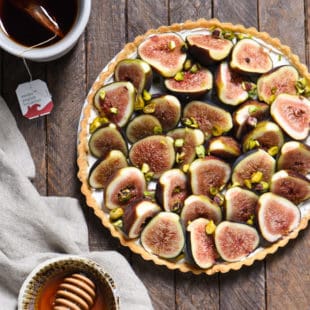 Fig & Spiced Goat Cheese Tart - A "dessert" for all the cheese lovers out there. Ripe figs are piled into a flaky crust on top of sweet and savory spiced goat cheese, then topped with honey and pistachios. | foxeslovelemons.com