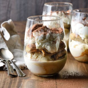 Stemless wine glasses filled with layered frozen tiramisu.