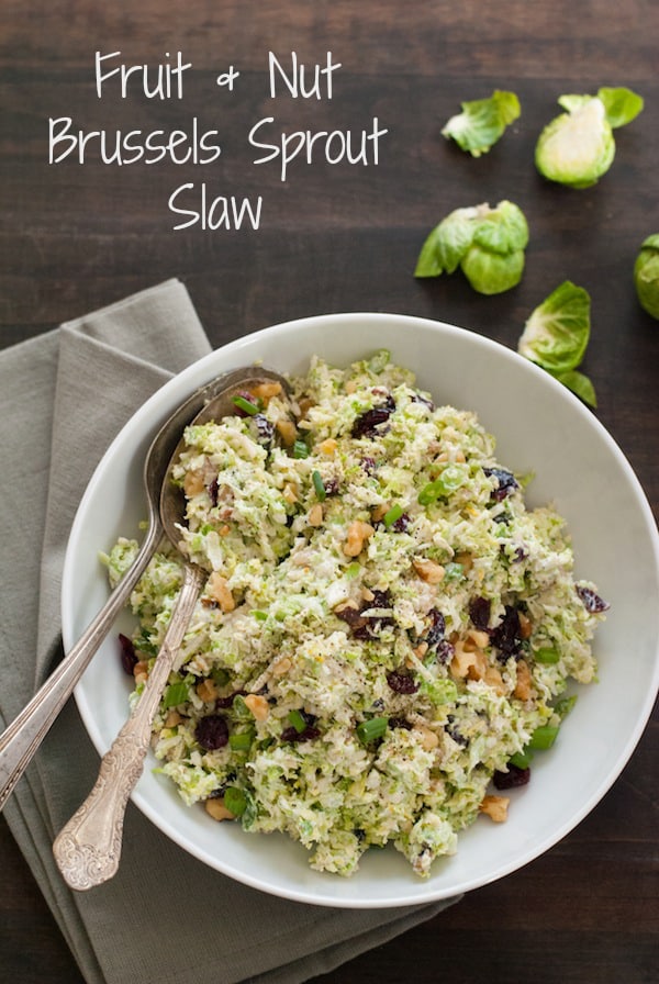 Fruit & Nut Brussels Sprout Slaw - A healthful and tasty coleslaw made with shredded brussels sprouts, dried cranberries and walnuts, tossed with a tangy yogurt-orange dressing! | foxeslovelemons.com