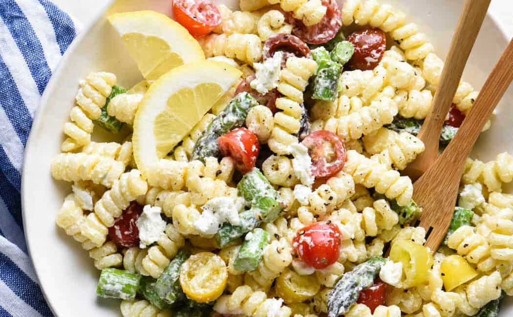 This creamy goat cheese pasta salad is simple to put together and will become a family favorite! Customize with any vegetables you like. | foxeslovelemons.com