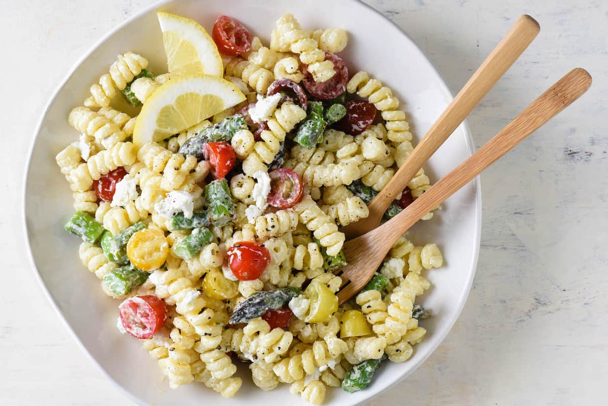 This creamy goat cheese pasta salad is simple to put together and will become a family favorite! Customize with any vegetables you like. | foxeslovelemons.com