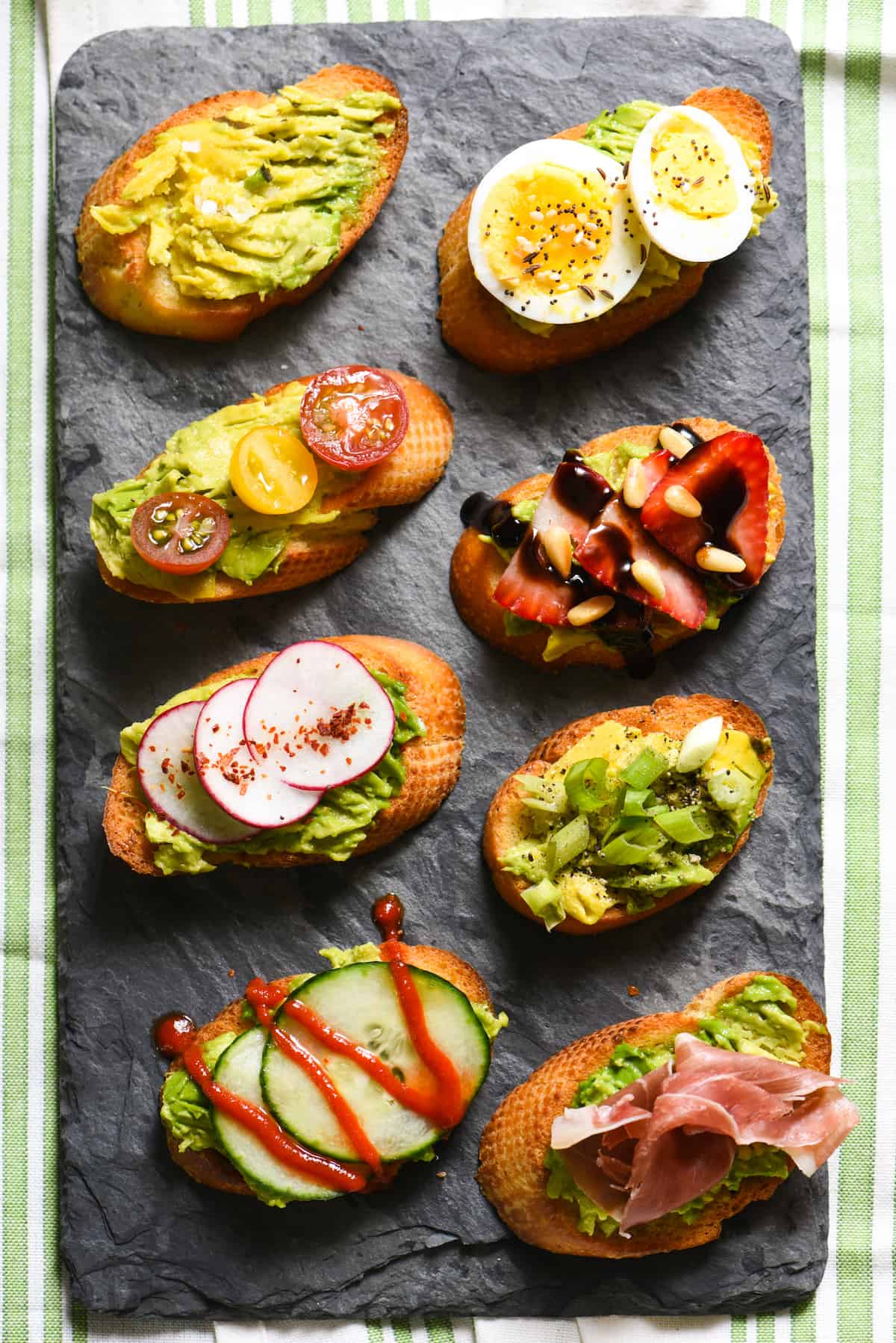 Grilled Avocado Crostini Board - A fun party idea! Pile a bunch of fresh toppings onto a big platter, and let your guests assemble their own grilled avocado crostini! | foxeslovelemons.com