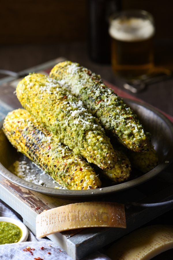 Grilled Parmesan-Pesto Sweet Corn - 4 ingredients. 8 minutes cook time. The best summer side dish ever! | foxeslovelemons.com