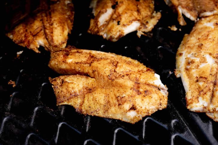 Tilapia being cooked on a grill.