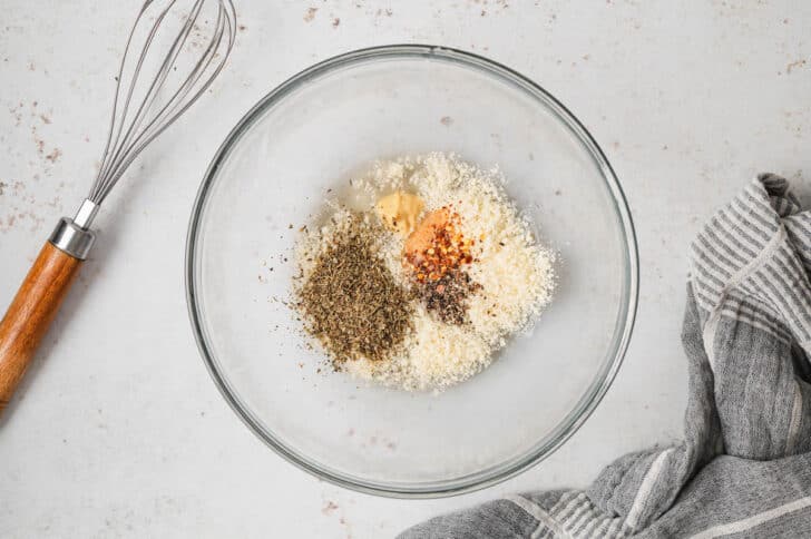 DIY Italian dressing being made in a glass bowl.