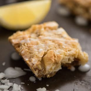 Lemon Coconut Dream Bars - A tropical treat that will whisk you away to an island! Graham cracker crust is topped with a lemon-infused coconut and almond topping, and a lemon glaze. | foxeslovelemons.com