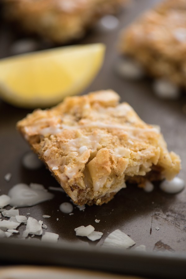 Lemon Coconut Dream Bars - A tropical treat that will whisk you away to an island! Graham cracker crust is topped with a lemon-infused coconut and almond topping, and a lemon glaze. | foxeslovelemons.com