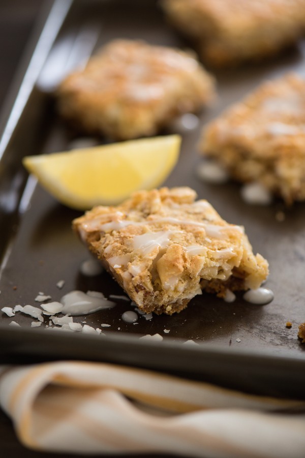 Lemon Coconut Dream Bars - A tropical treat that will whisk you away to an island! Graham cracker crust is topped with a lemon-infused coconut and almond topping, and a lemon glaze. | foxeslovelemons.com