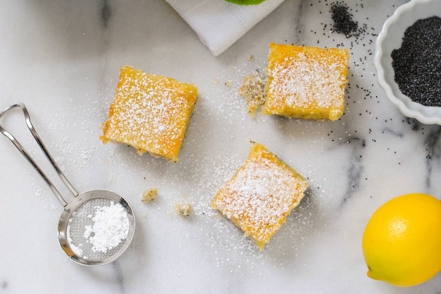 Meyer Lemon Bars with Poppyseed Crust - A flaky poppyseed crust topped with tart and sweet Meyer lemon filling. | foxeslovelemons.com