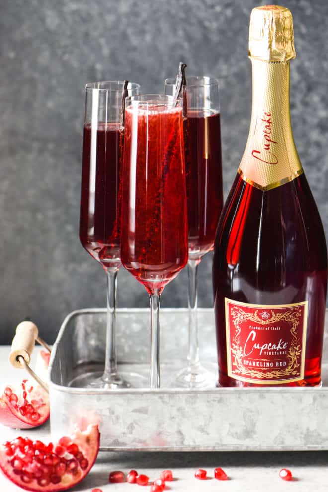 Pomegranate Vanilla Sparking Wine Cocktails - 3 ingredients + 5 minutes = this festive, fruity, bubbly cocktail. Cheers! | foxeslovelemons.com