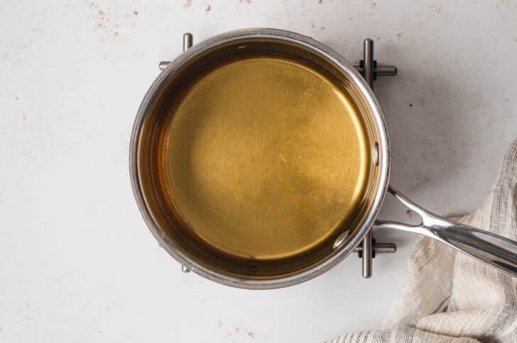 A saucepan filled with a golden liquid.