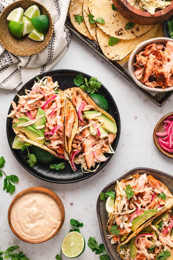 A dinner scene featuring a salmon taco recipe with creamy sauce.