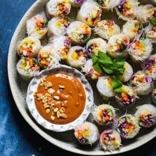 Serve the rainbow with these Salmon Fresh Rolls with Spicy Peanut Sauce. Perfect as a bright party appetizer or healthful dinner, be a "home chef" and make this takeout-inspired recipe at home! | foxeslovelemons.com