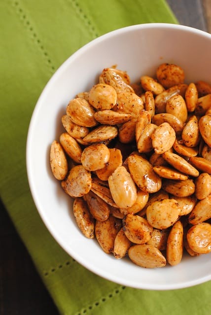 Overhead photo of marcona almonds in white bowl, a food to serve with sangria.