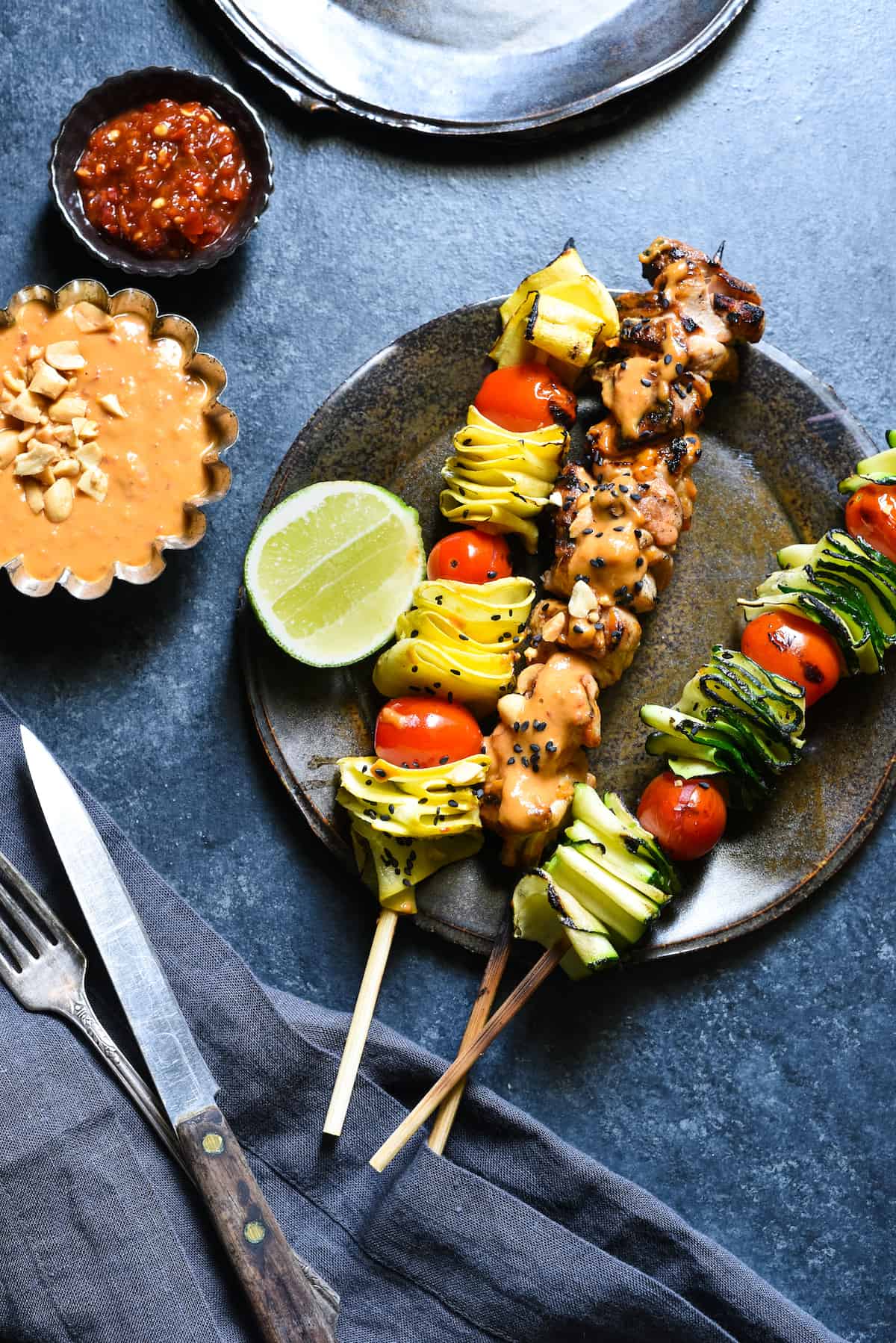 Spicy Peanut Chicken Skewers - The whole family will love this easy grilled take on peanut chicken satay. Serve with veggie skewers for a complete meal! | foxeslovelemons.com